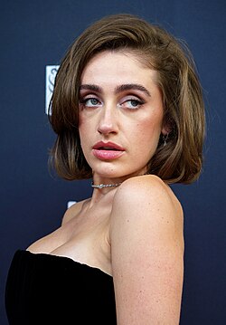 A woman in a black strapless dress at a film festival entry carpet