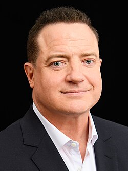 Fraser looking to the camera, wearing a suit