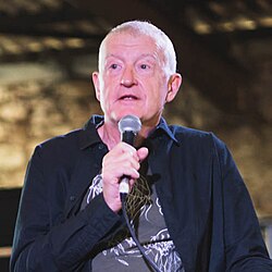 Photo of Davis holding a microphone