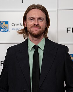 O'Connell facing head on to the camera with a slightly parted lip smile