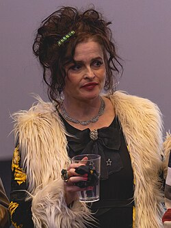 Helena Bonham Carter onstage, holding a cup