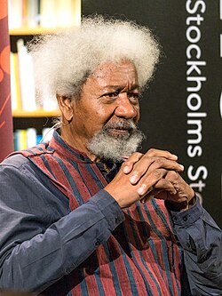 An aged black man, with white hairs and medium-sized moustache