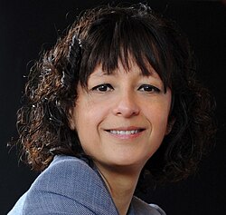 a photograph of Charpentier, a white woman with curly brown hair, smiling slightly