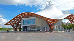 Modern museum building with curved white roof