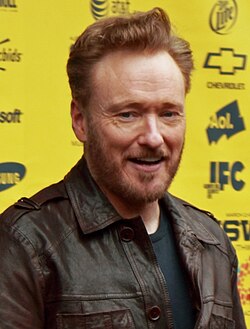 Medium shot of Conan O'Brien smiling at the camera